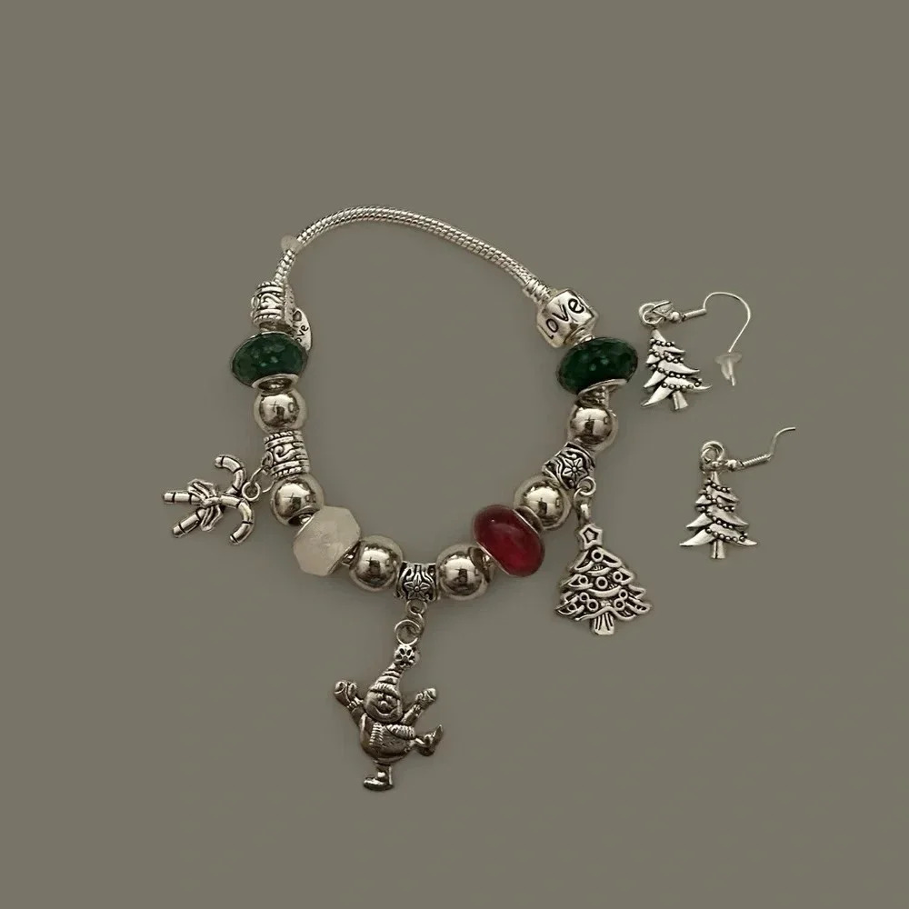 Homemade earrings and bracelet with red, green, white, silver beads and…